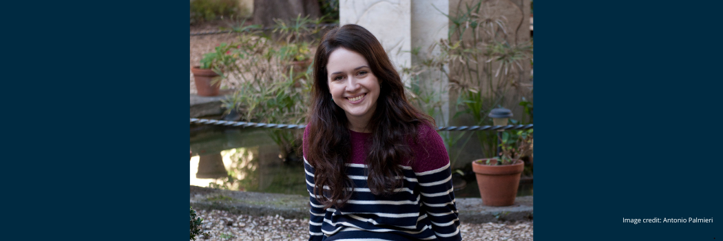 Dr Katherine McDonald smiling and facing the camera whilst sat in an outdoor setting