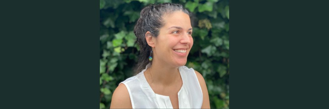 Woman smiling, looking off camera to right