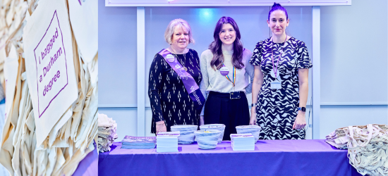 Alumni staff at a stand at Congregation Fair
