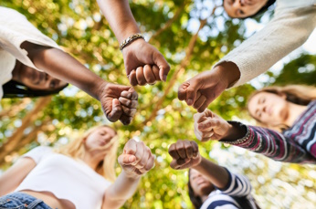 Group of people holding hands in a circle