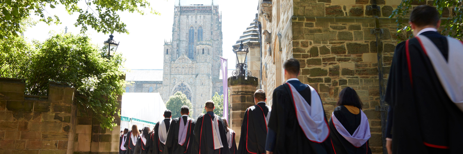 Students graduation with cathedral in the background