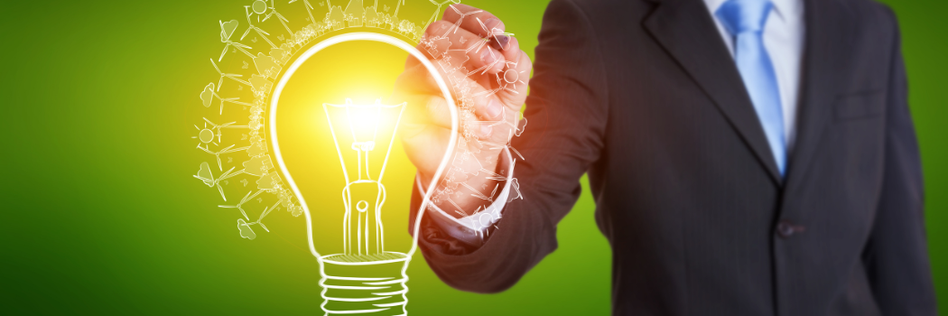 Businessman on blurred background drawing renewable eco lightbulb sketch