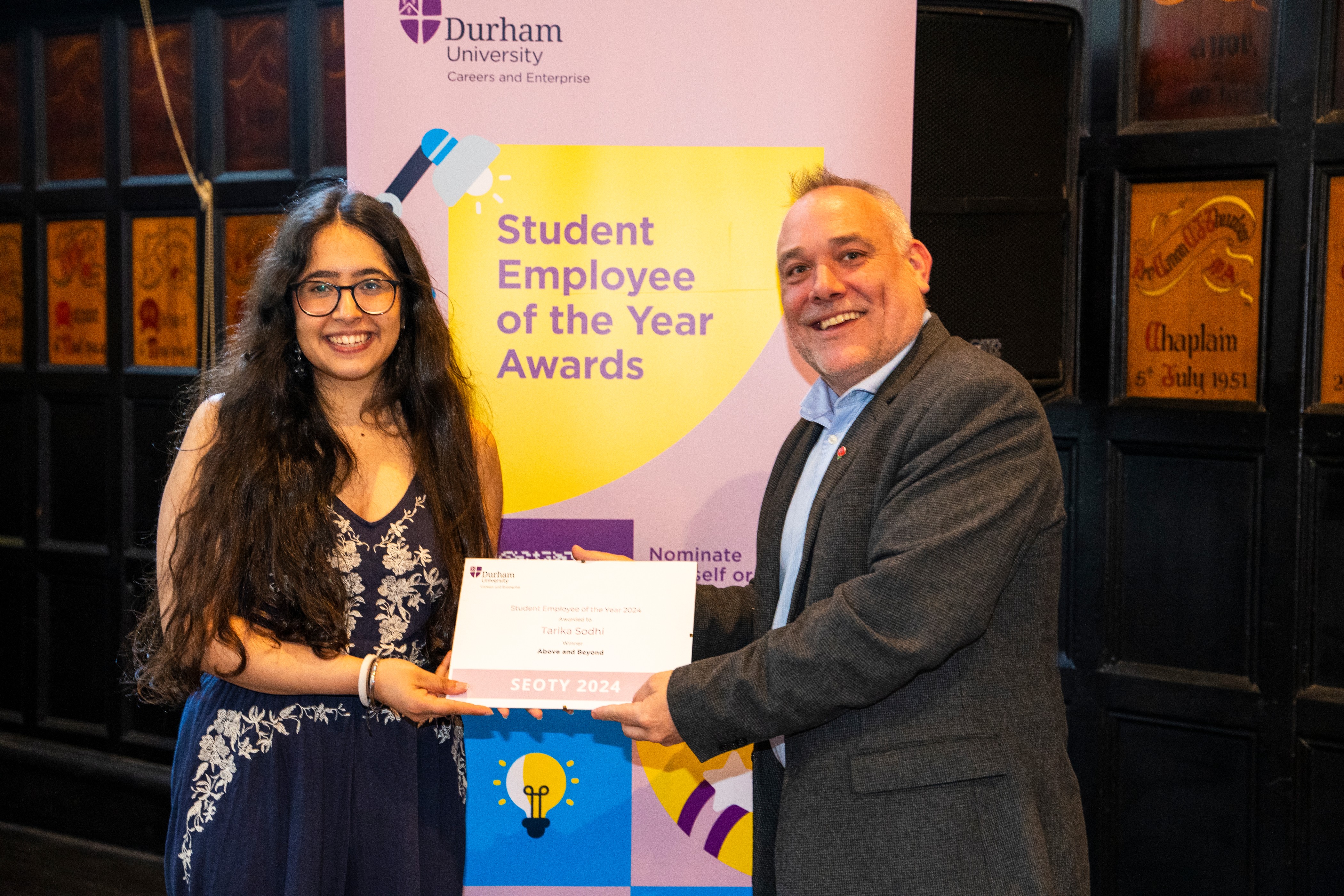 Tarika Sodhi collects the Above and Beyond: Off Campus Award