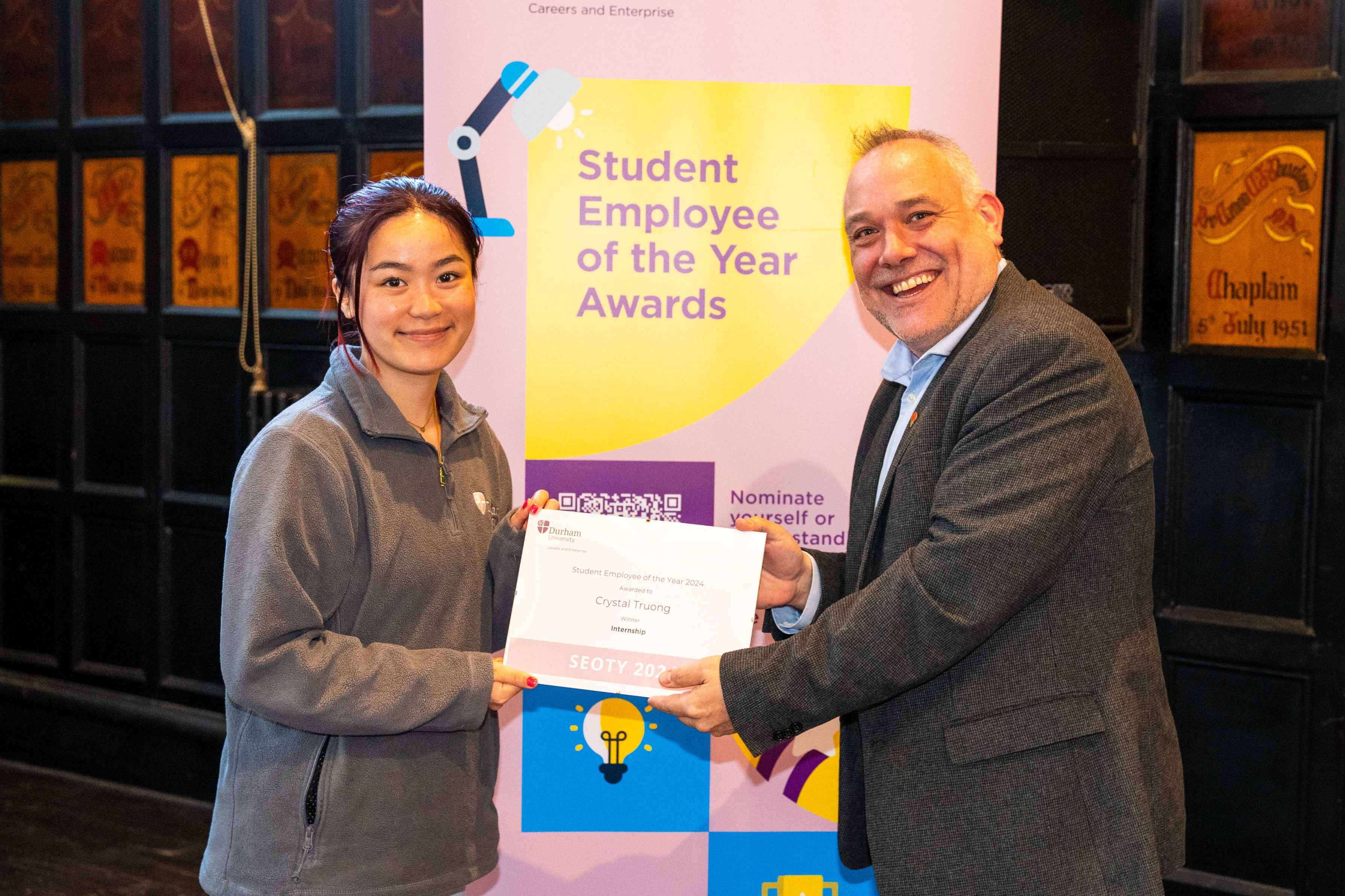 Crystal Truong collecting the Overall Student Employee of the Year Award at the Student Employee of the Year Awards 2024