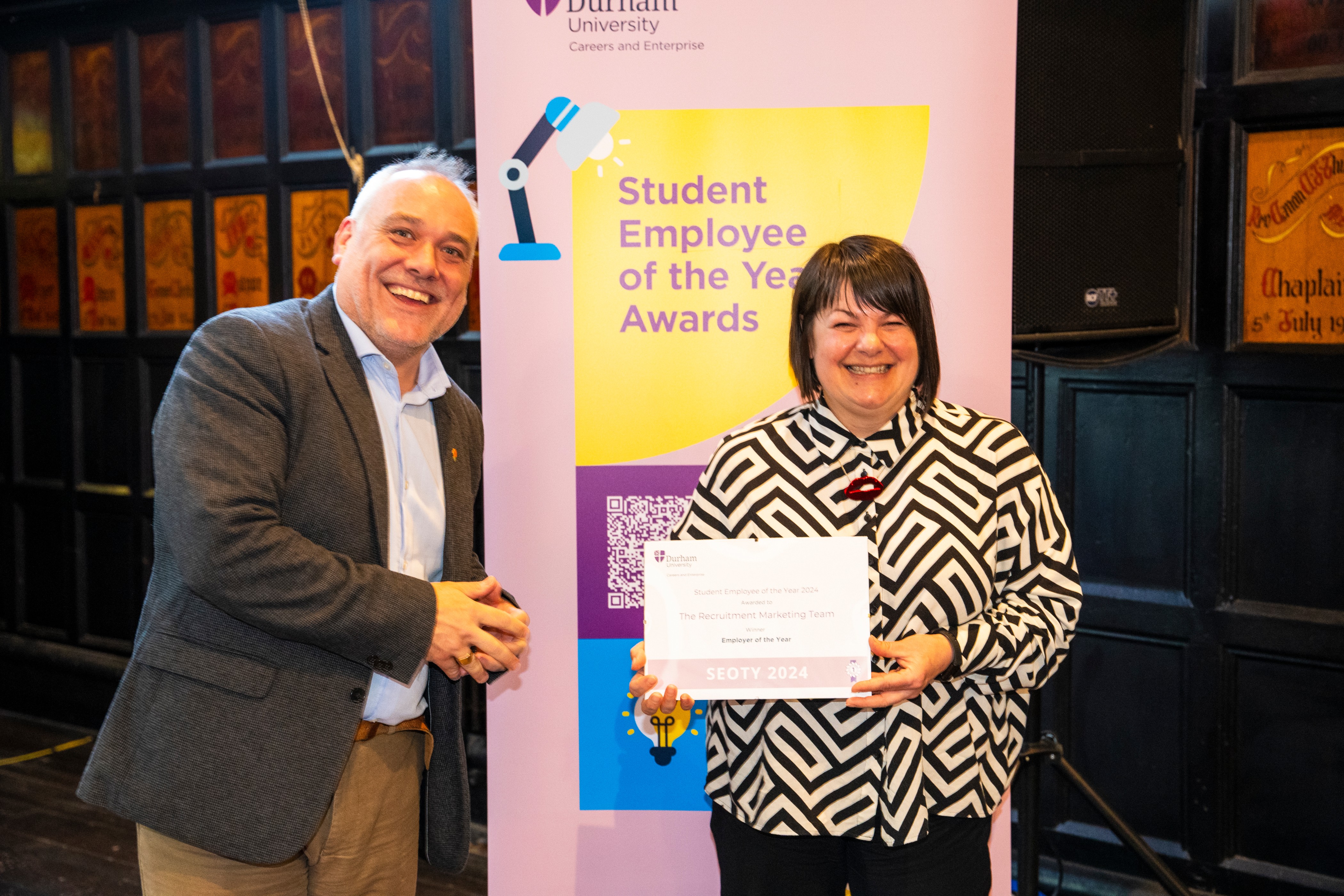 A representative from The Student Recruitment Marketing Team collecting the Student Employer of the Year Award (On Campus) at the SEOTY 2024