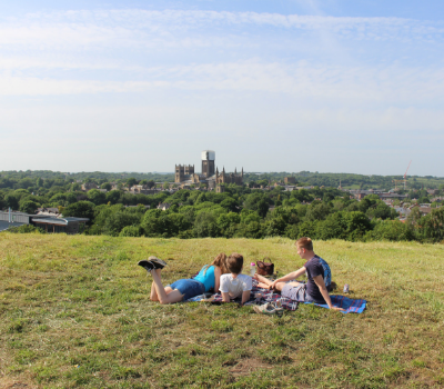 Students looking at Durham Cathedral in the distance