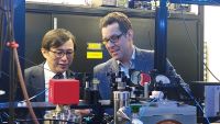 Two people looking at scientific equipment
