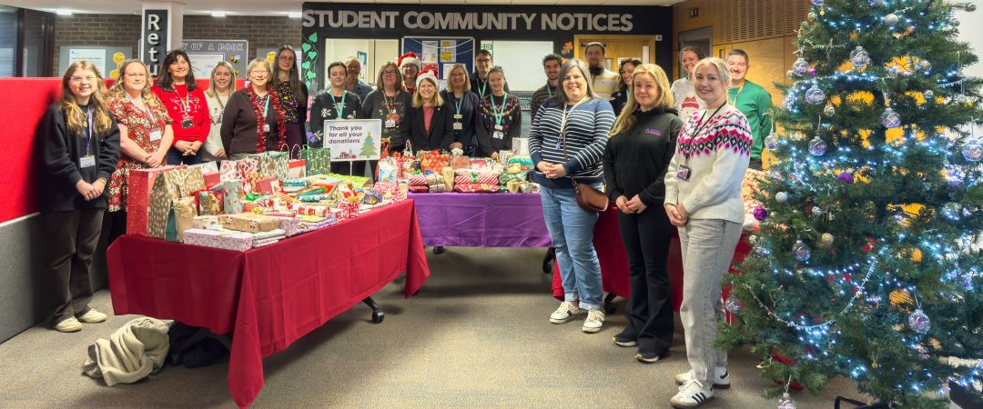 Staff and student with Christmas gift donations to the Christmas Wish Tree appeal