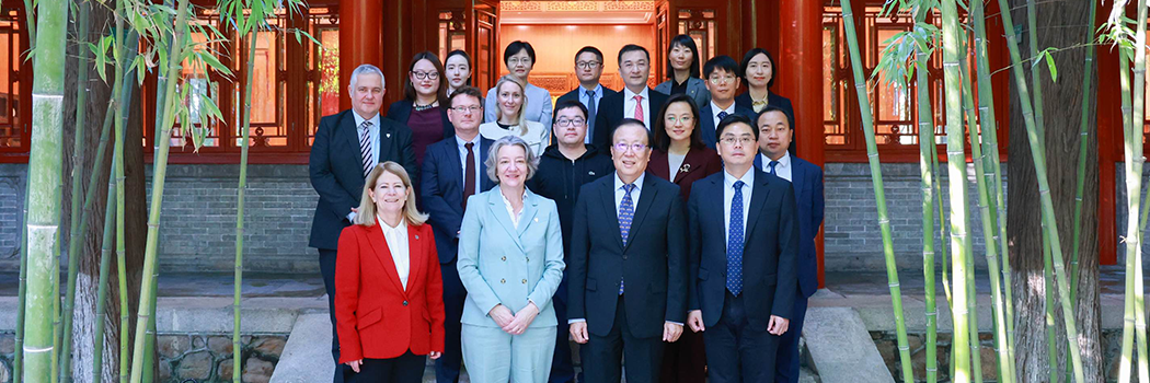 a group standing for a photograph with bamboo either side of them