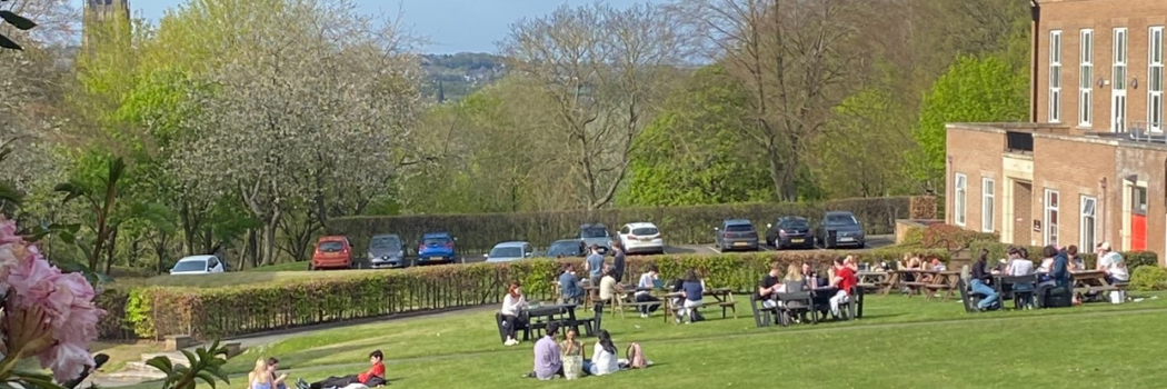 Students on lawn in front of college