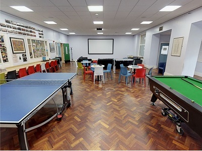 TStudent common room with a table tennis, pool table and group seating