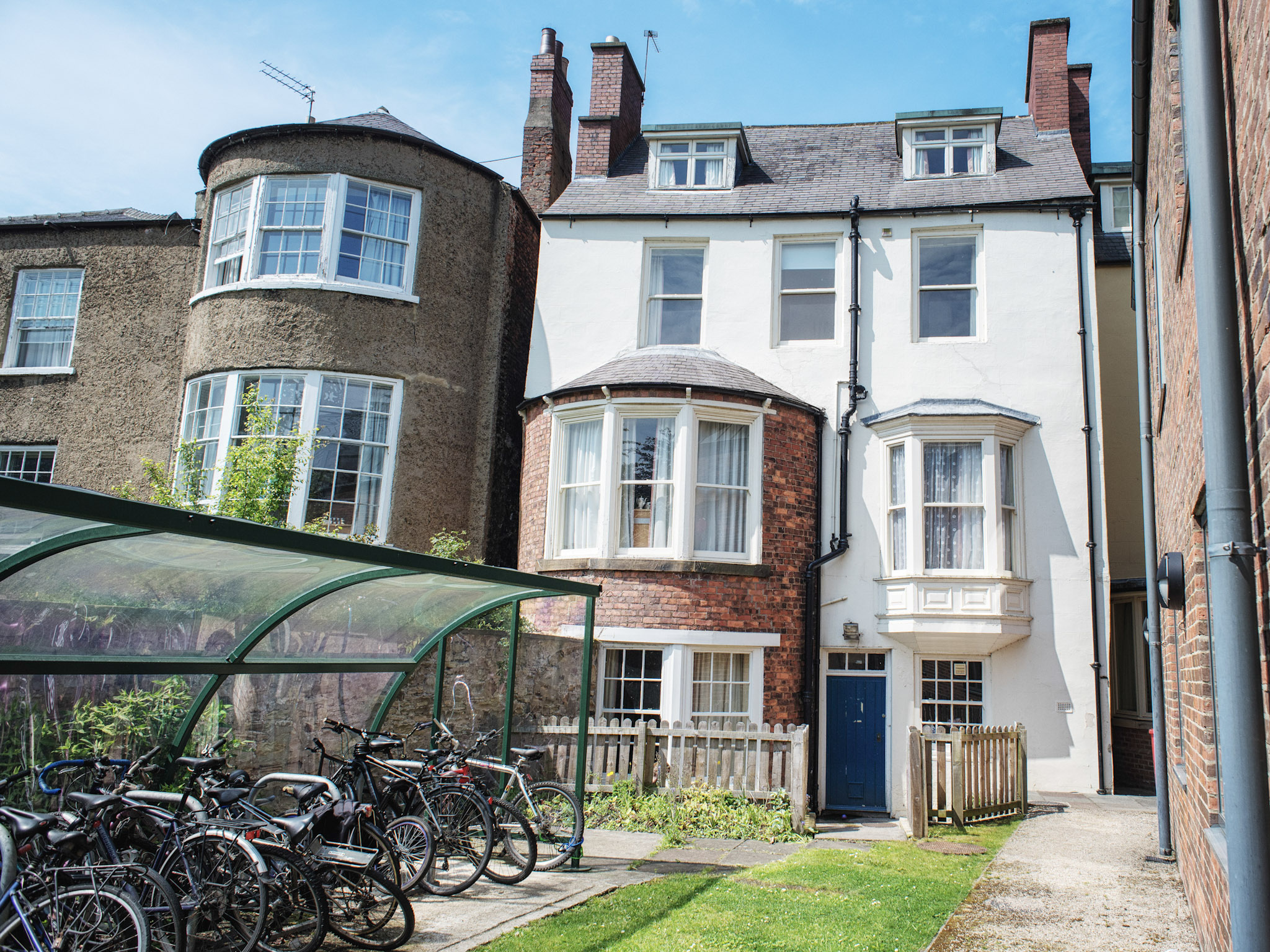 Bike under a shelter outside the front of a house
