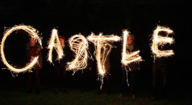 The word castle written in the air with light on a dark background