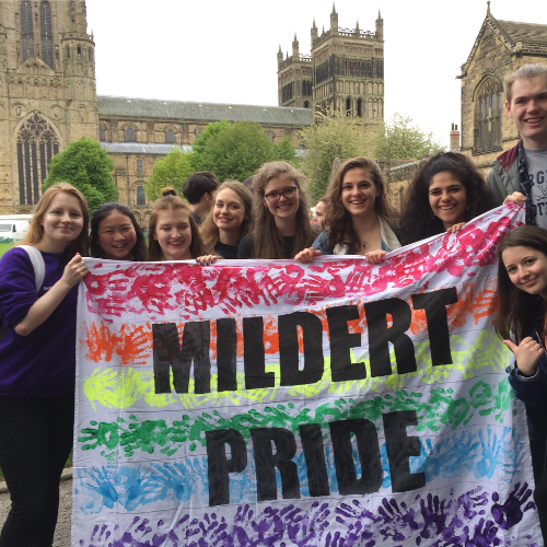 Students behind a 'Mildert Pride' banner