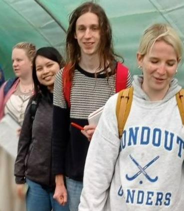 a group of people in a polytunnel at Nixxiegha Olive grove