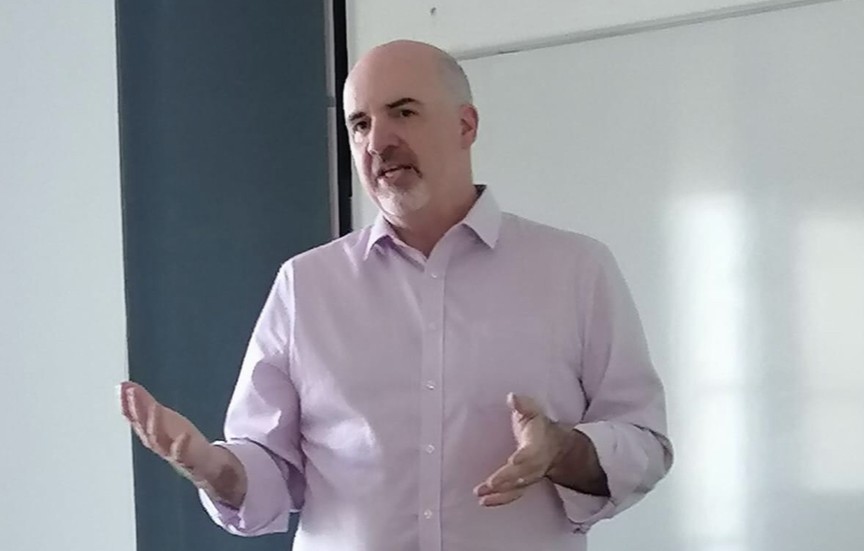 Thom Brooks in front of a whiteboard