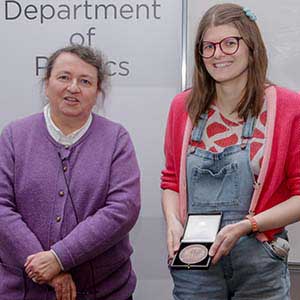 Photograph of Amy receiving his award, presented by Paula Chadwick.