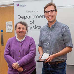 Photograph of Dan receiving his award, presented by Paula Chadwick.