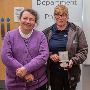 Photograph of Michelle receiving his award, presented by Paula Chadwick.