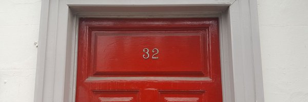 A red door with number 32 in gold lettering