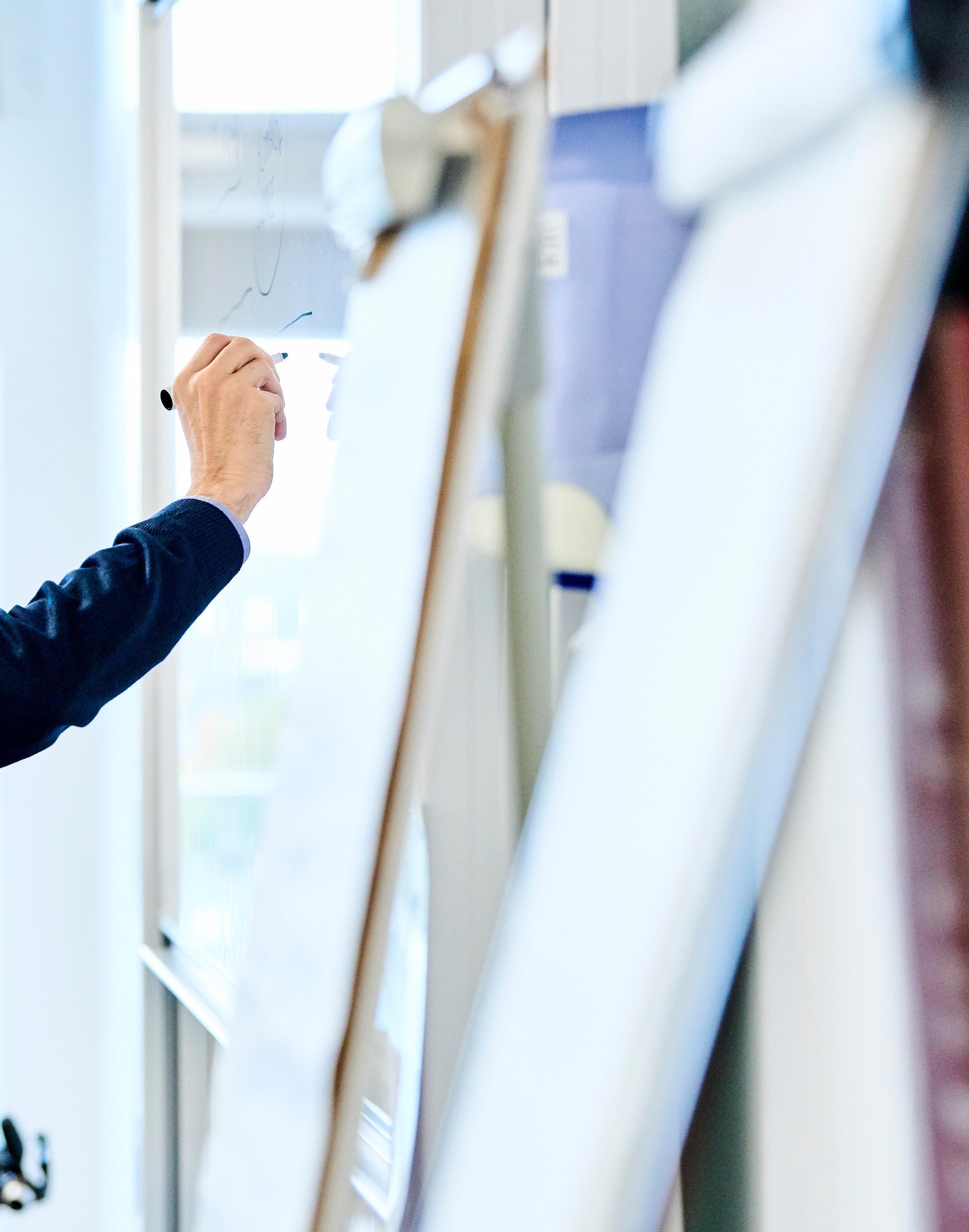 Lecturer writing on an easel board