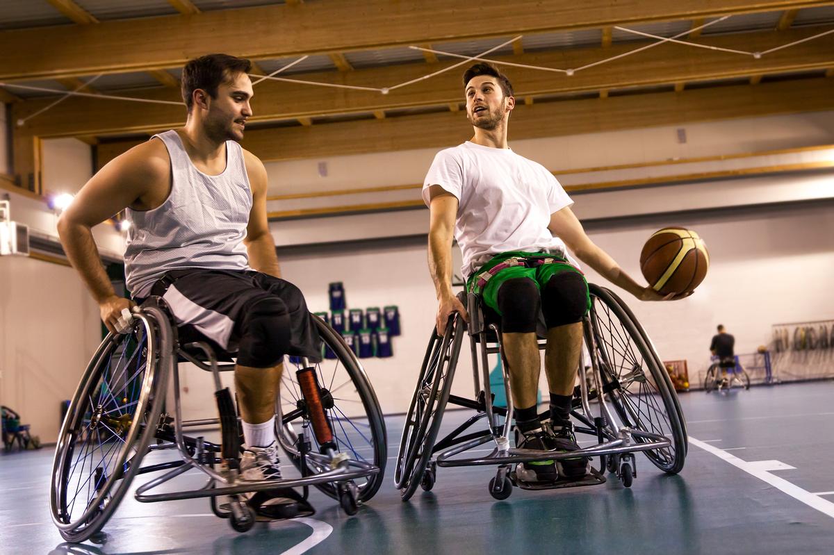 Two male athlete's participating in wheelchair basketball