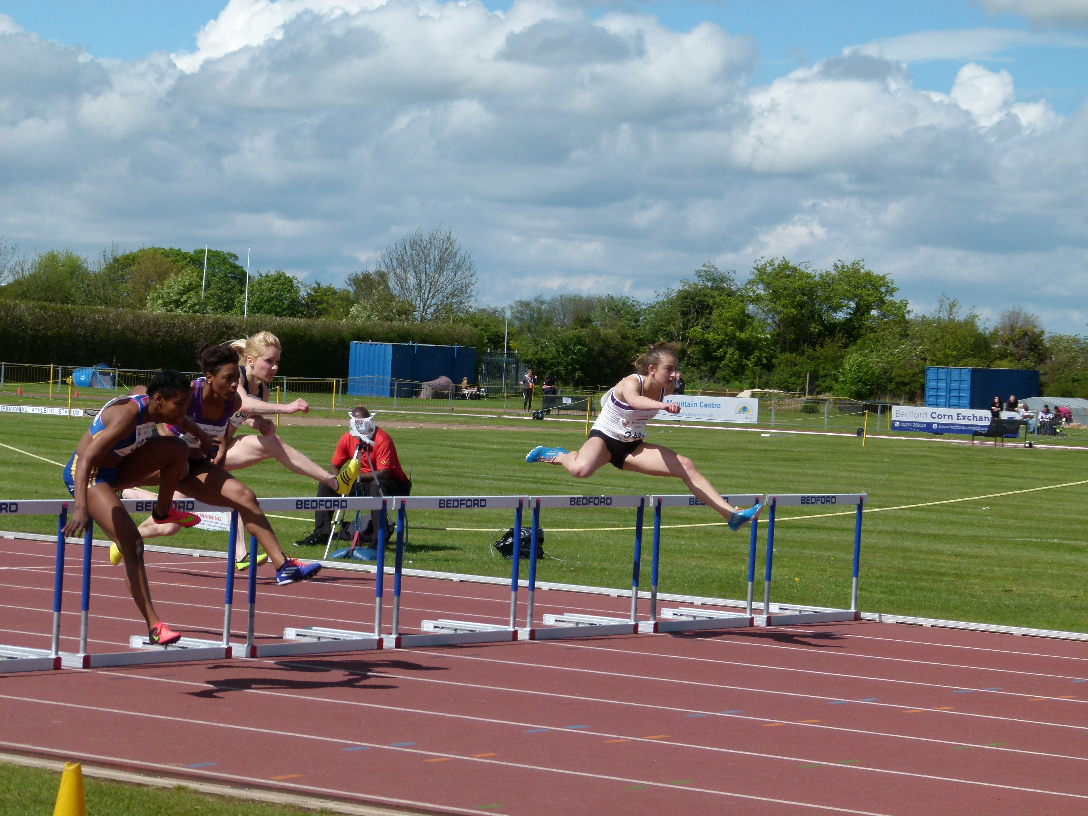 Athletes running a race over hurdles