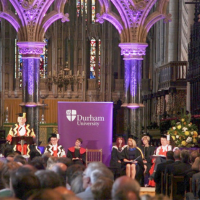 Durham University staff on stage inside Durham Cathedral