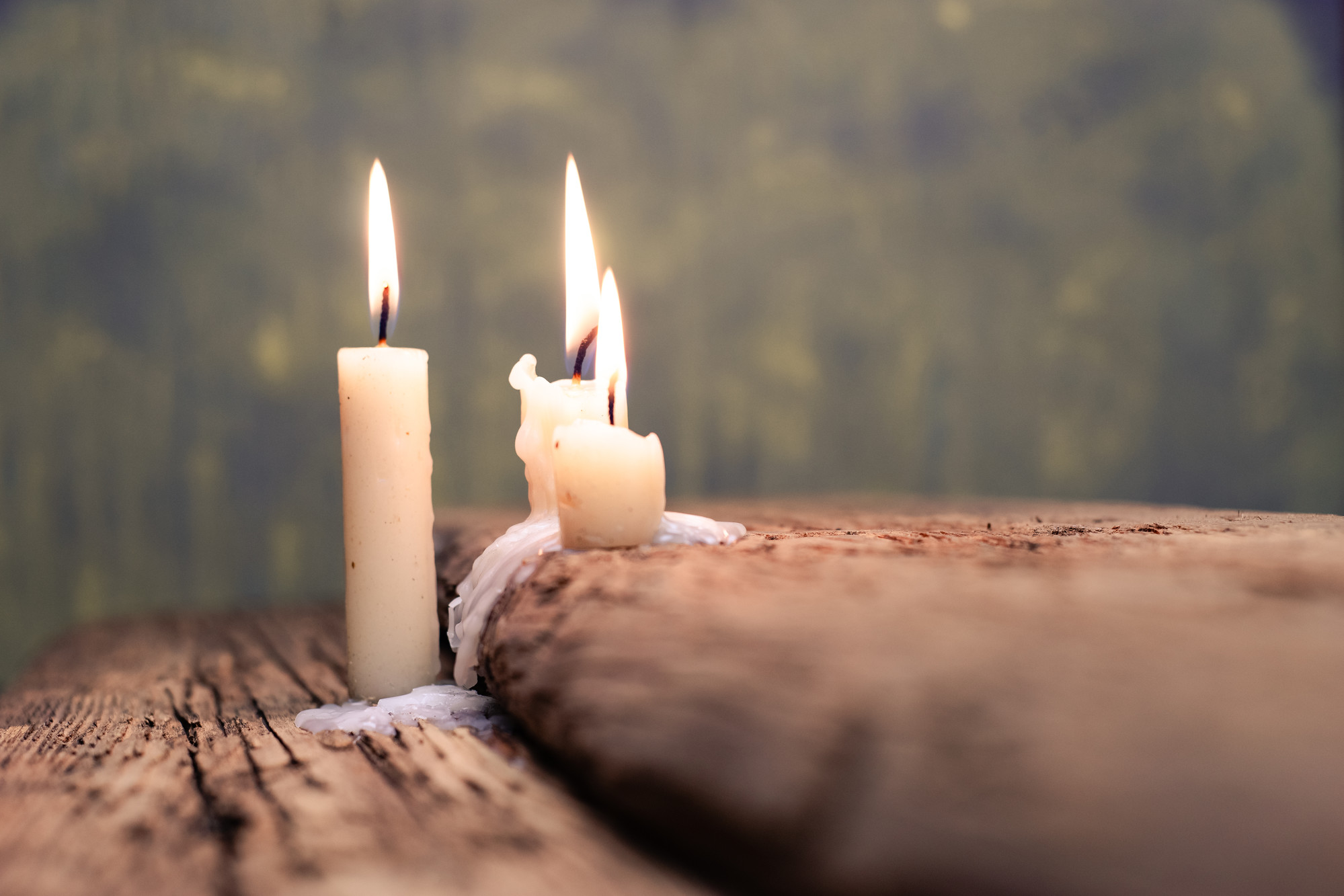 Candle on a old oak wooden table