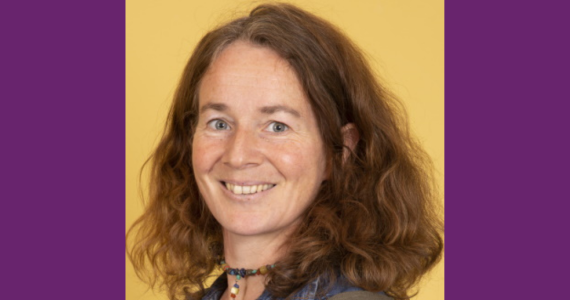 Headshot of white female with brown curly hair