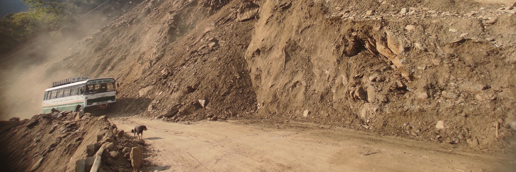 A bus travelling along a sandy road