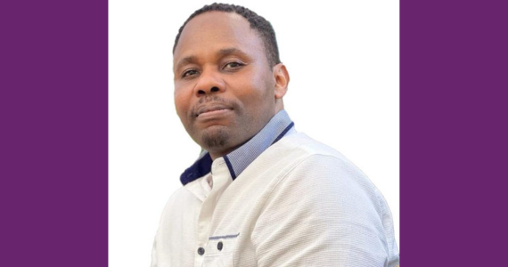 Head shot of male professor in a white shirt