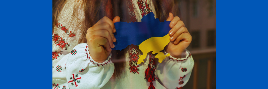 A girl holds a Ukrainian flag