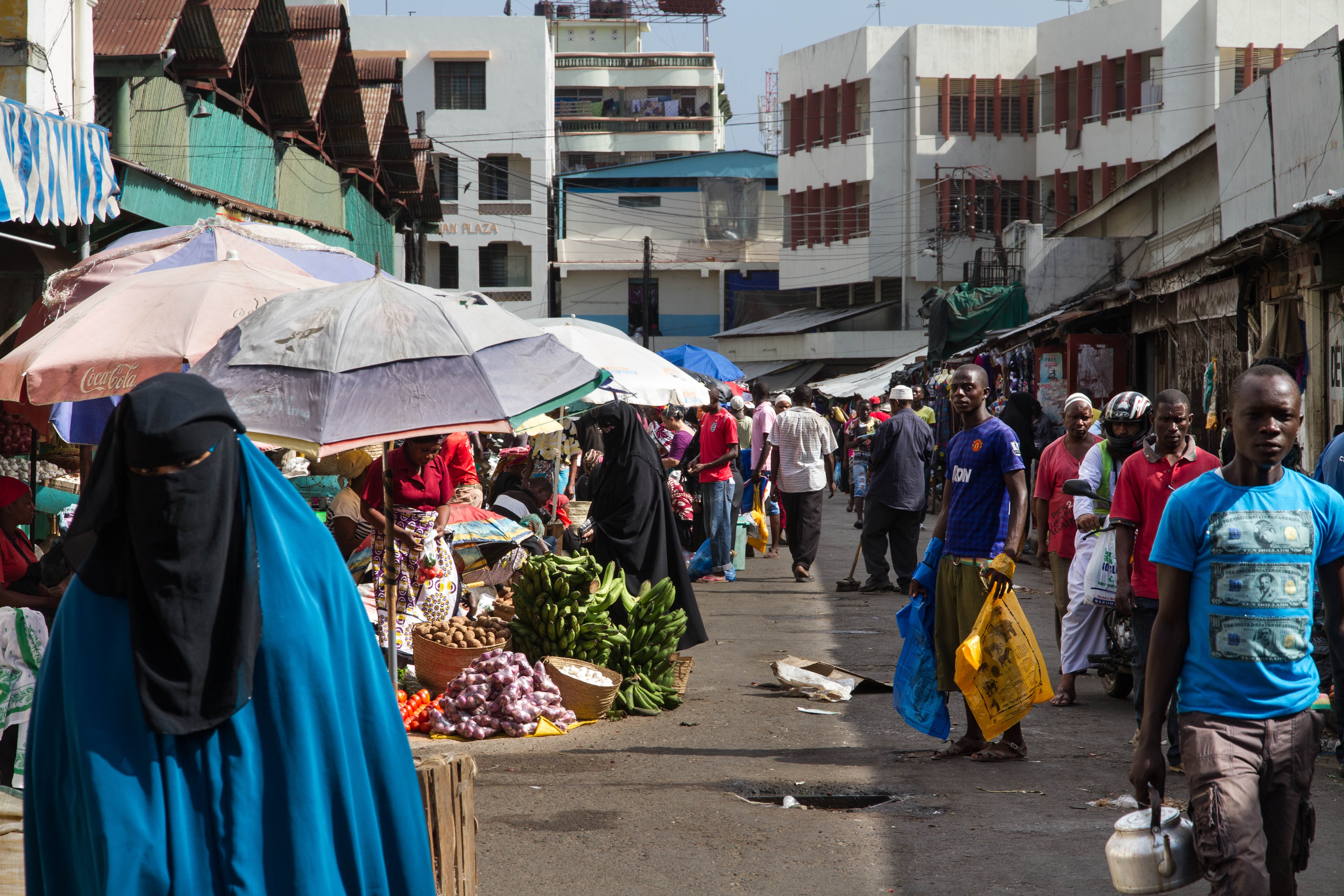 A market street in Kenya with various traders and pedestrians