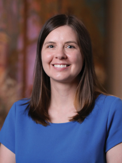 A smiling woman with long brown hair