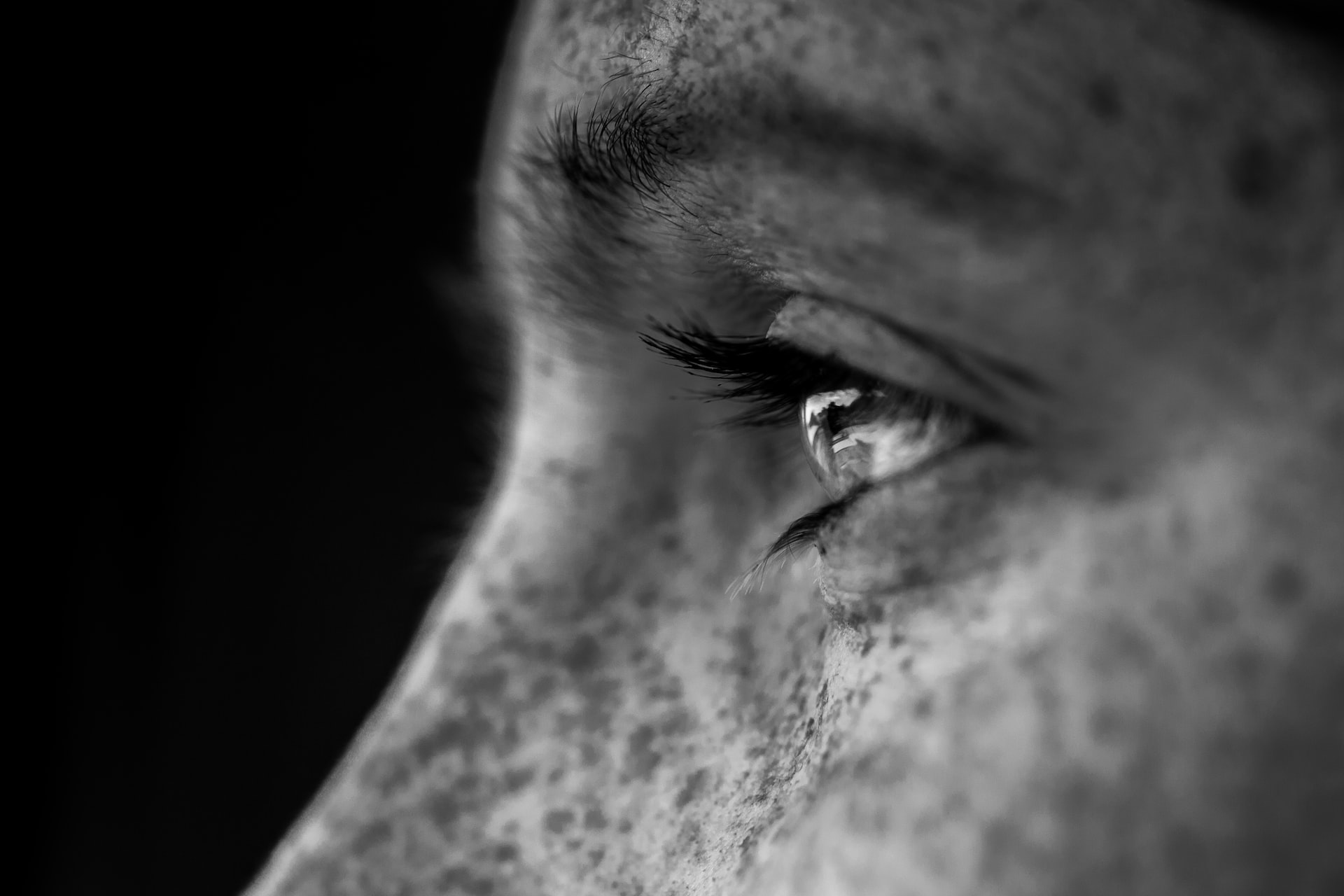 Black and white photo of the eyes of a man looking into the distance