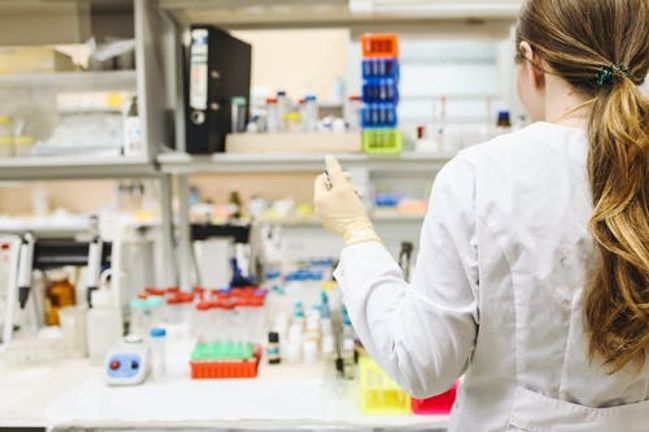 Researcher using micropipette