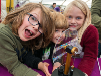 Three children experimenting with wind