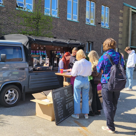 Students lining up in front of a coffee van