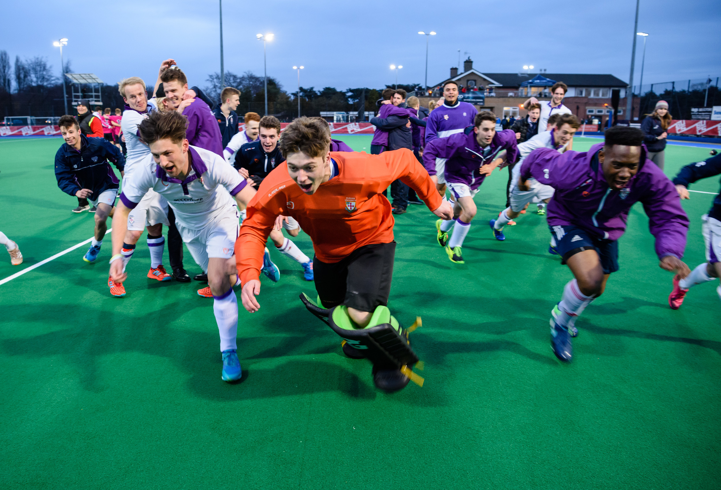 Hockey players running towards the camera