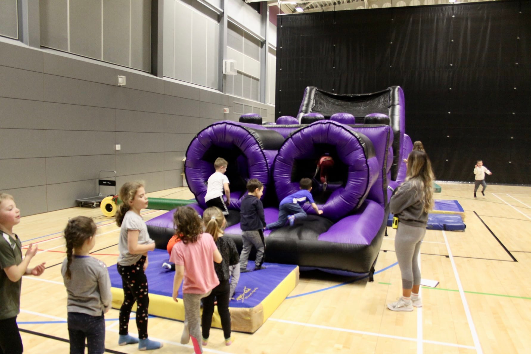 children playing on an inflatable obstacle course